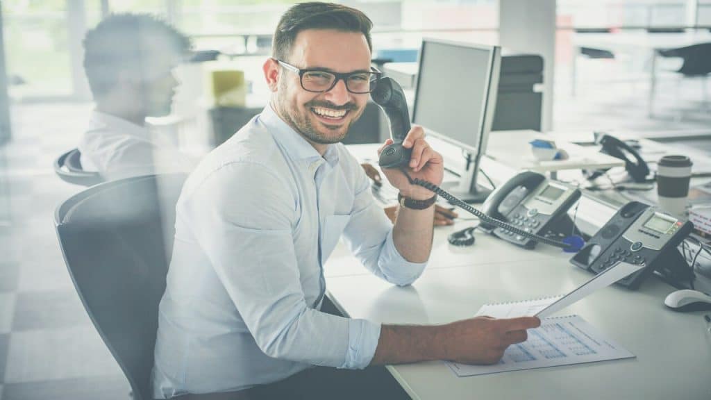 A man smiling while at work