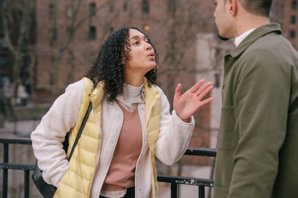 Young ethnic couple arguing on street