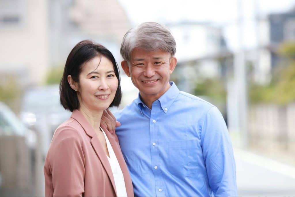 A man and woman smiling at the camera