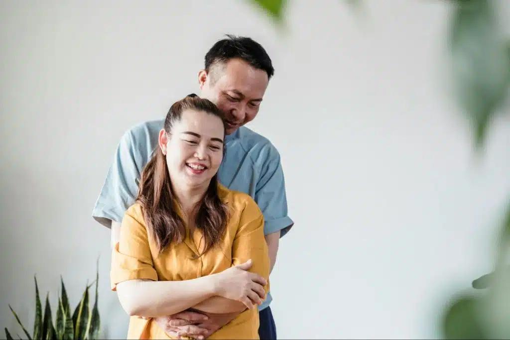 A man hugging a woman