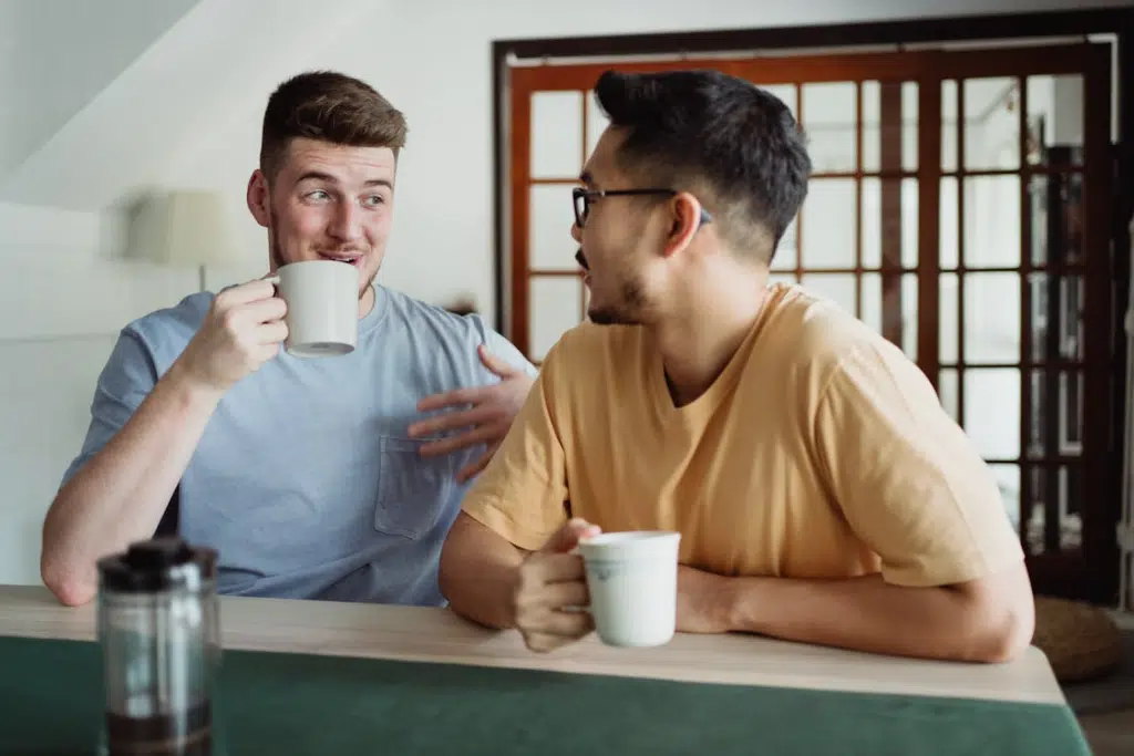 Men having a Conversation while Drinking Coffee