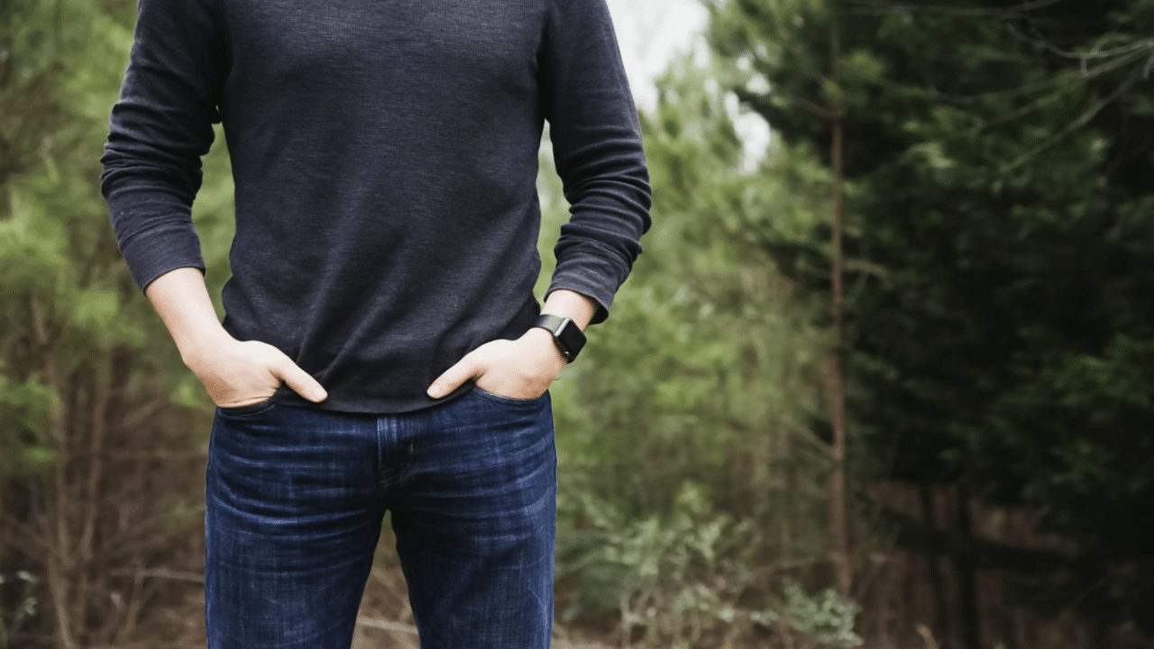 A man in a basic but well-fitting outfit