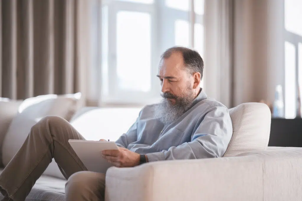 Photo of an elderly man writing