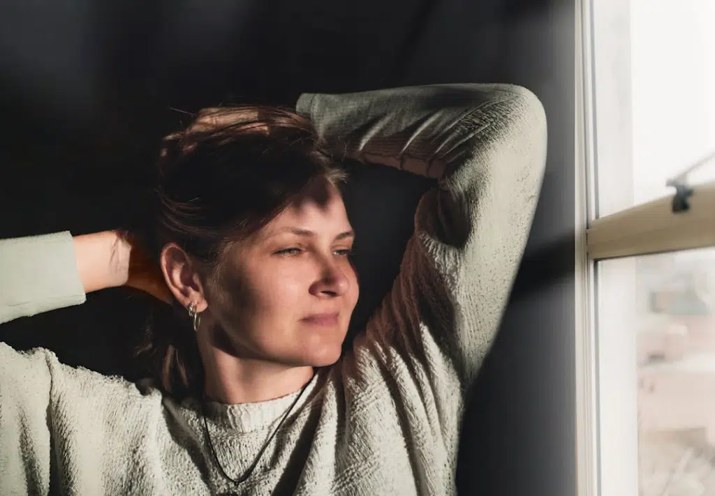 A woman smiling near the window
