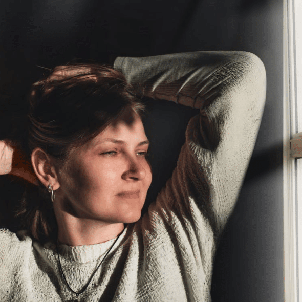 A woman smiling near the window