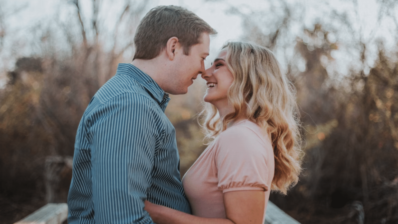 A couple about to kiss outdoors