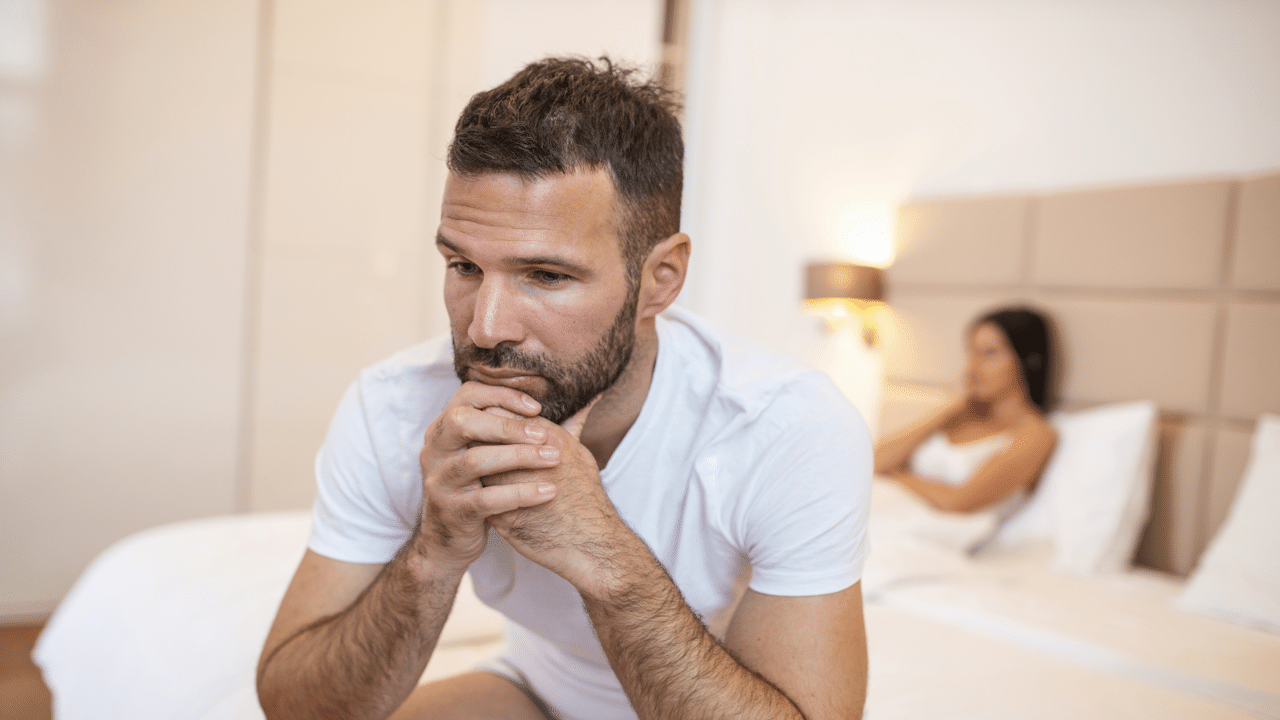 A man ignoring his wife in the bedroom