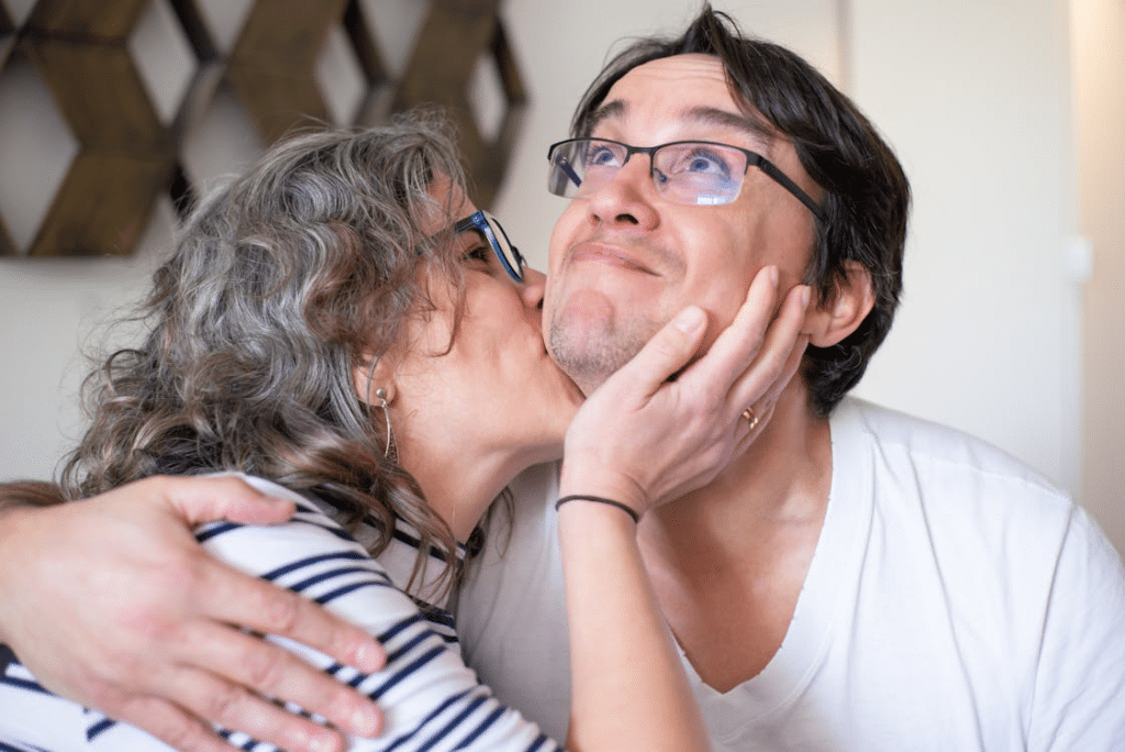 A woman kissing a man