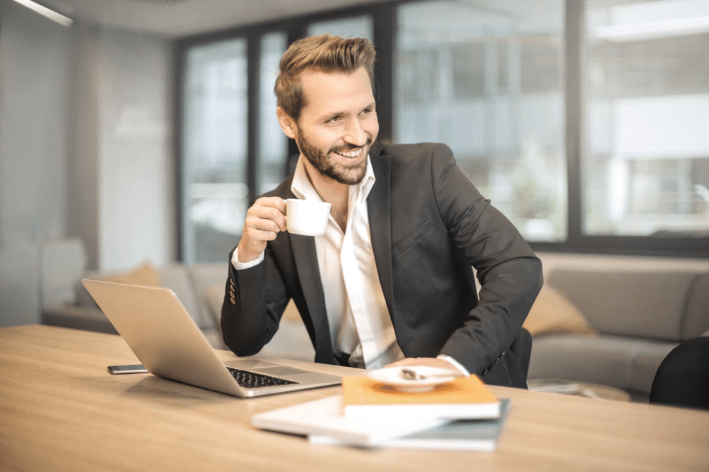 A man holding a white teacup