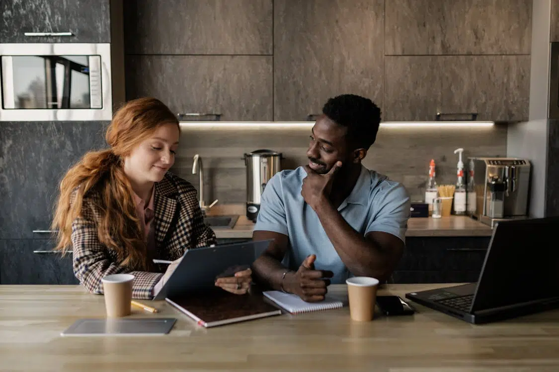 A man and a woman talking in the kitchen
