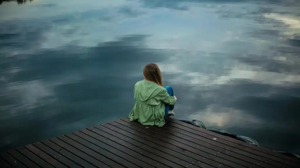 A woman sitting on a dock