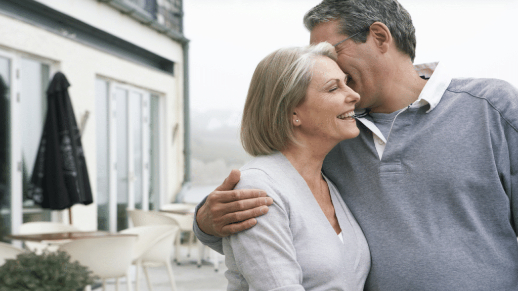 A mature couple outside a building