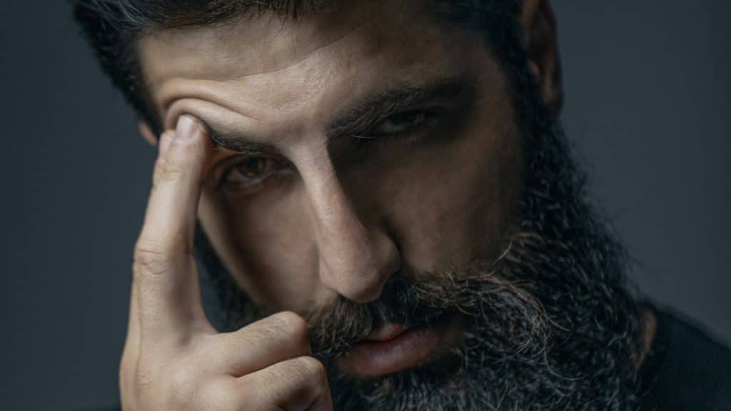 A man with a beard and a black shirt.