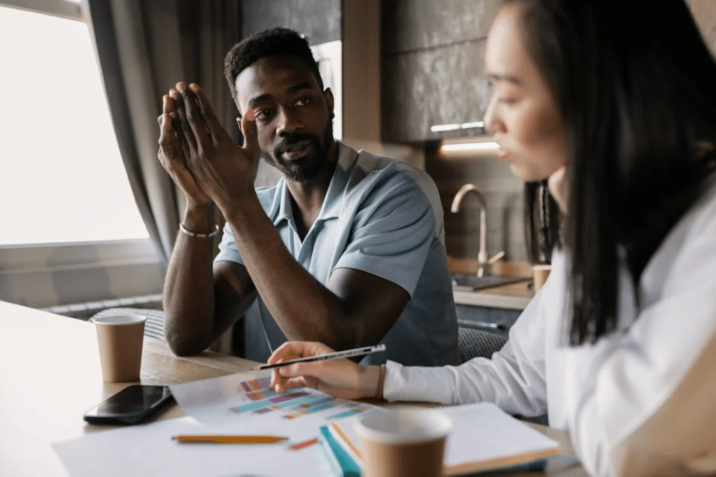 Photo of a Man and a Woman Brainstorming