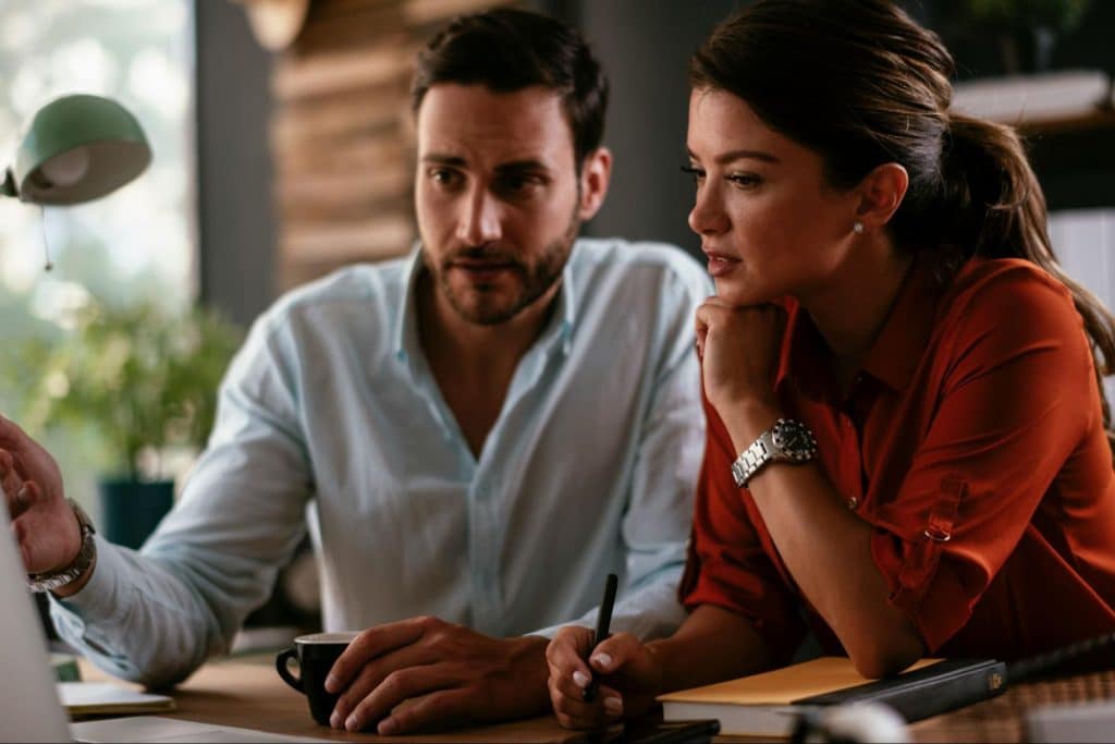 A man showing something to a woman