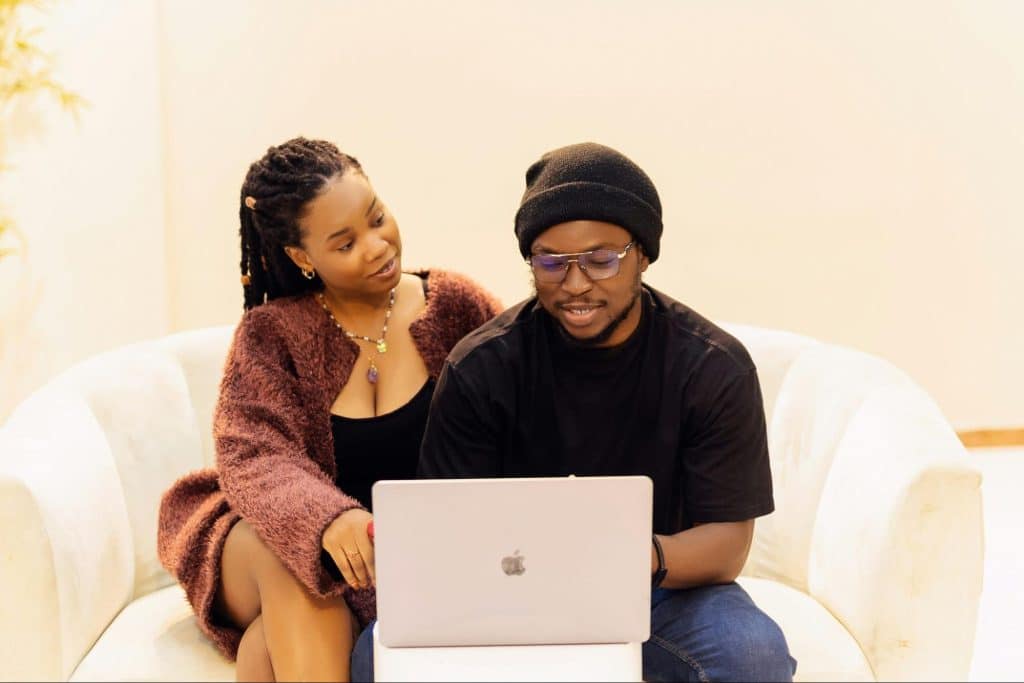 A man and woman using a laptop