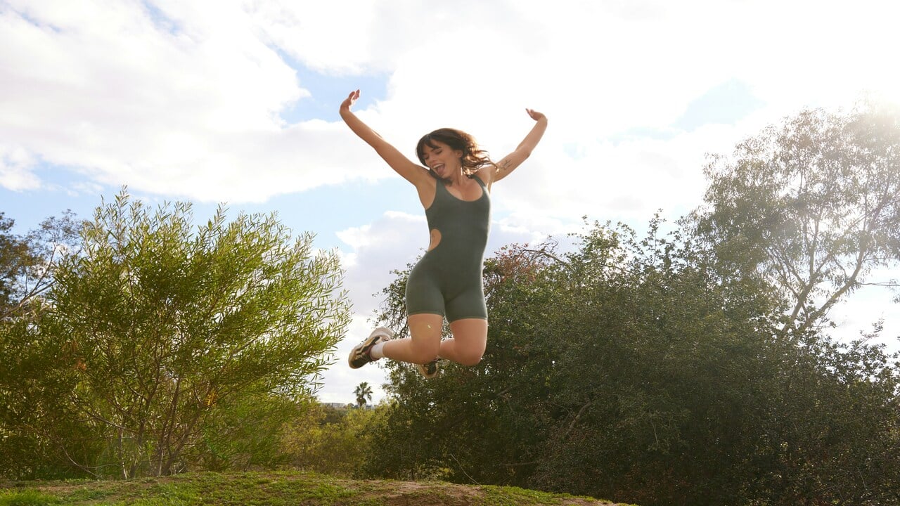 A woman jumping outdoors 