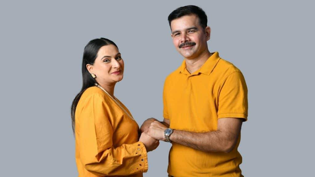 A couple holding hands standing next to each other.
