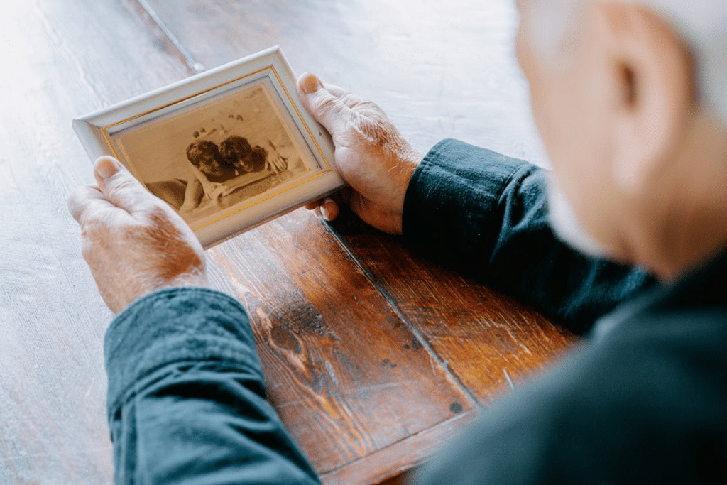 A Man Holding an Old Photograph