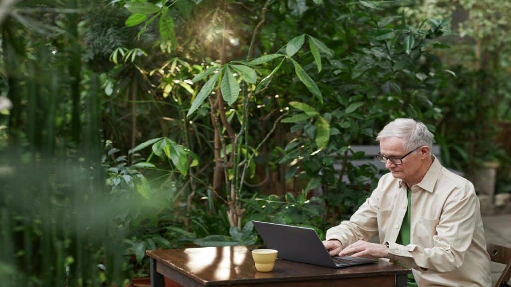 An older man using his laptop 