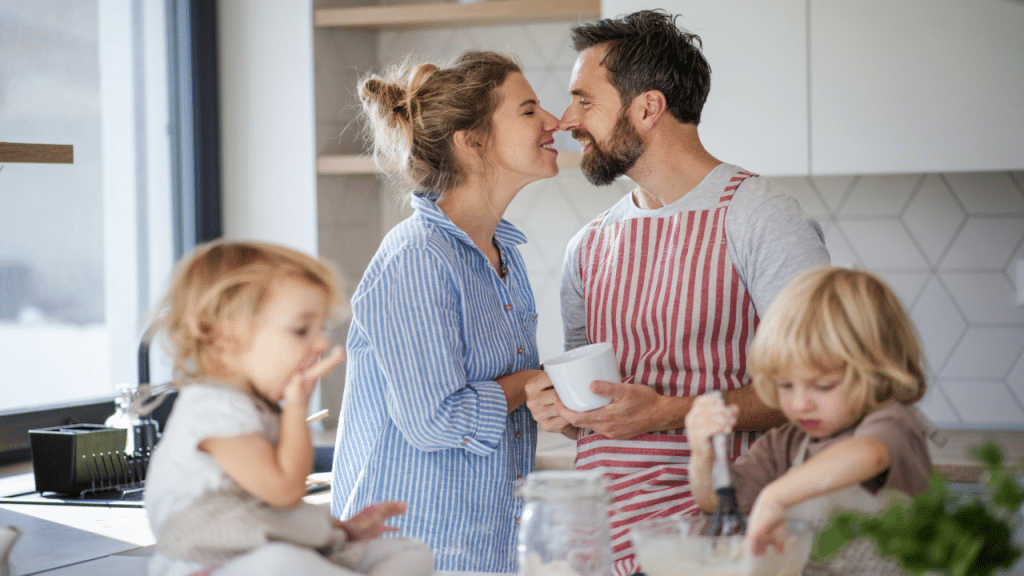 A couple kissing in the kitchen