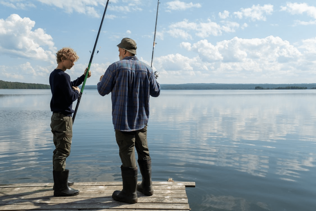 Father and Son Standing on a Pier and Fishing