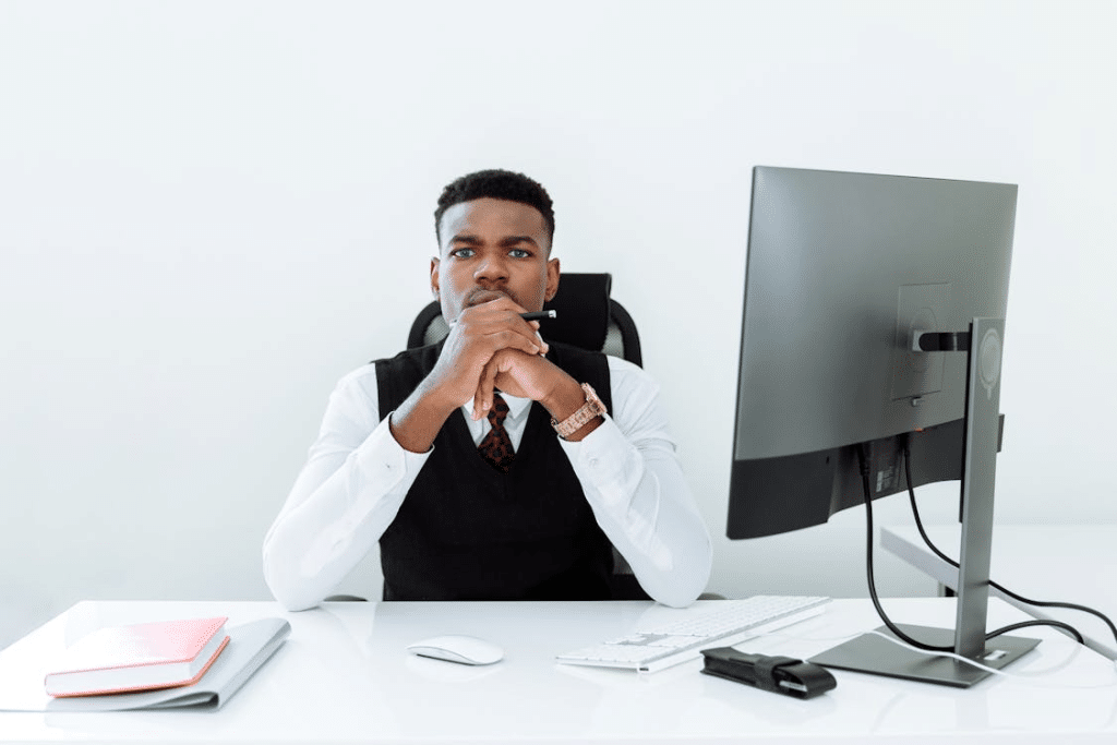 A Man Sitting Behind His Office Desk