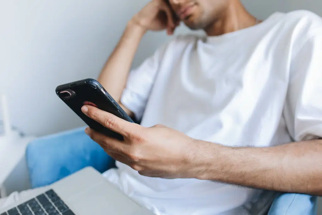 Man sitting with laptop and smartphone