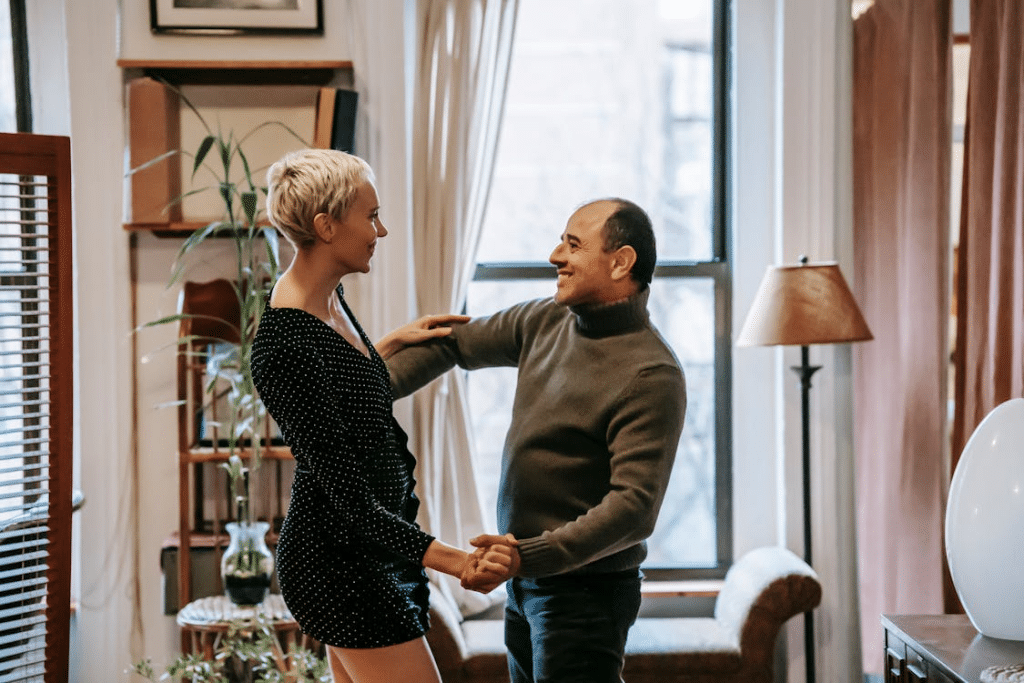 Couple dancing near the window
