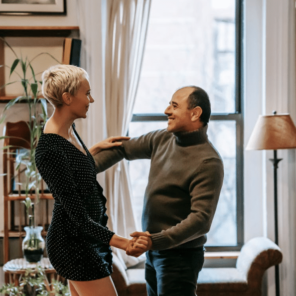 Couple dancing near the window