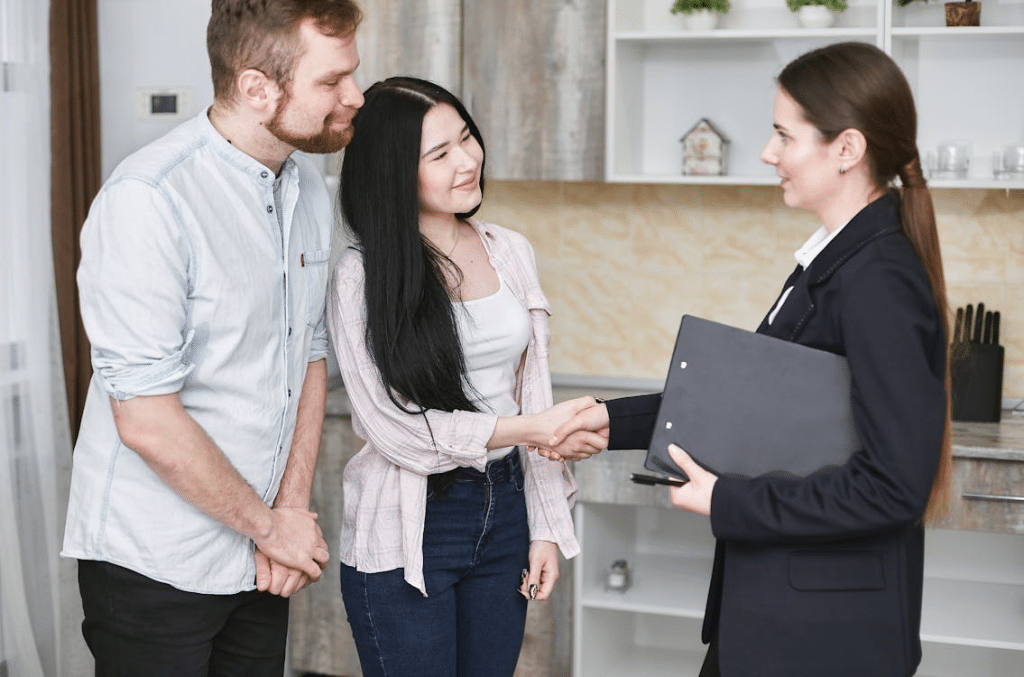 A woman talking to a couple