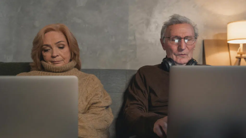 An elderly couple working from home