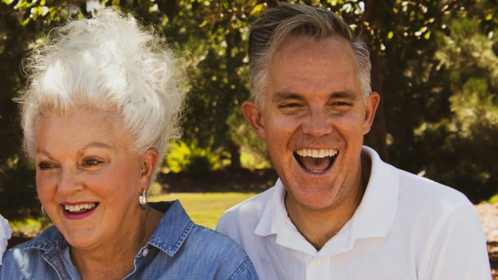 An older couple laughing together.