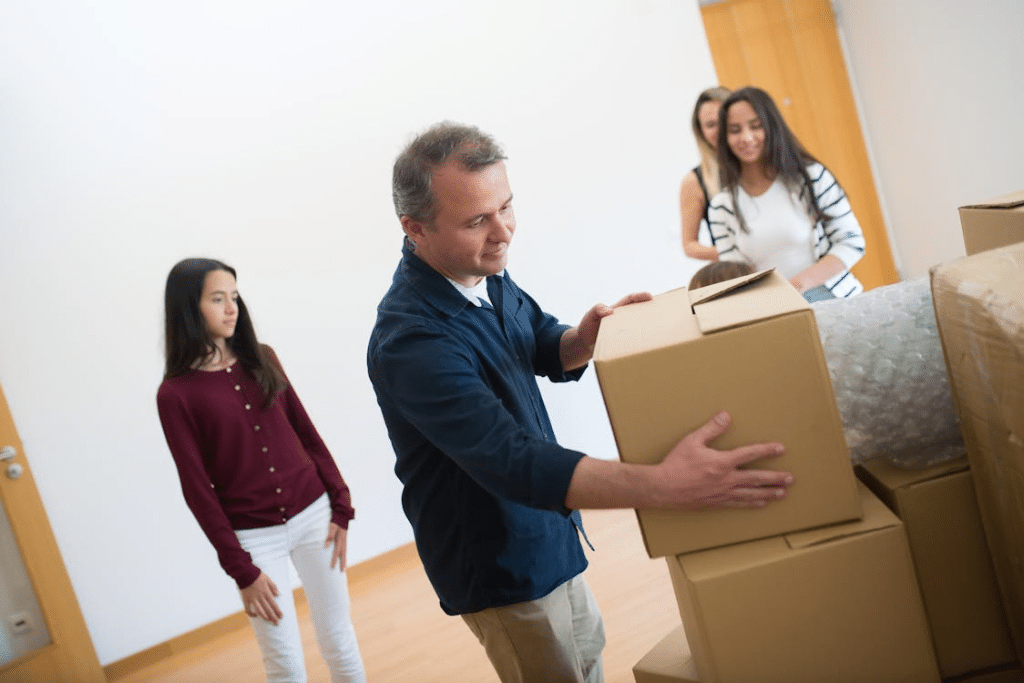 A family standing next to a pile of boxes