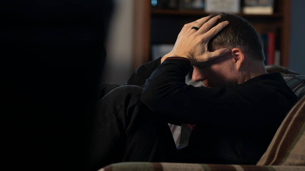 A man looking frustrated at home