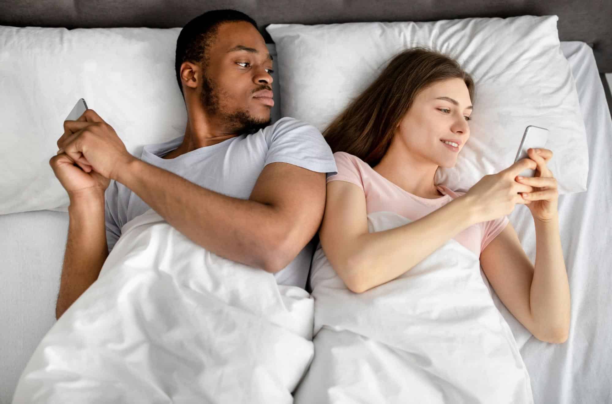 A man and woman using a phone 