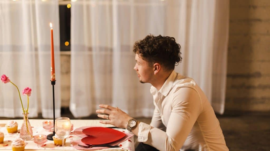 A man sitting at a table with a heart on the plate.