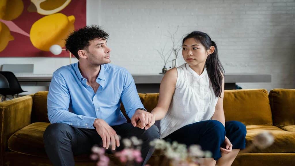A couple looking at each other in the living room