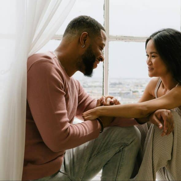 A man and woman facing each other
