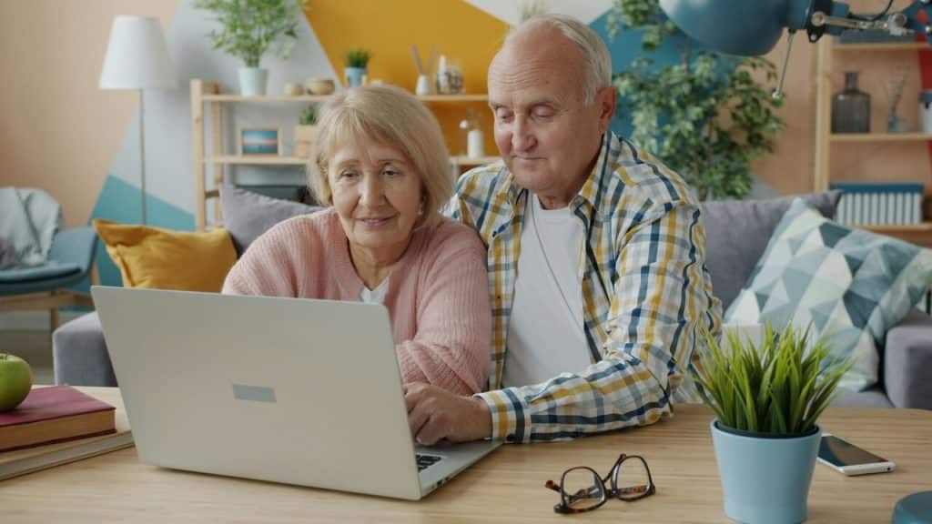 A couple looking at a laptop together