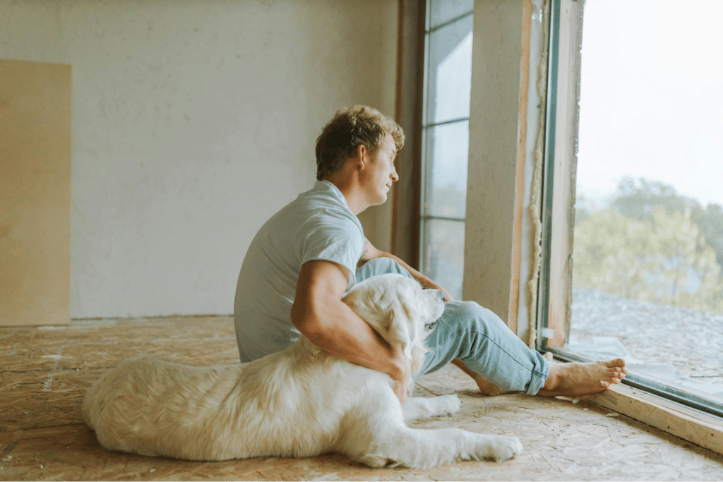A Man Sitting Beside His Pet