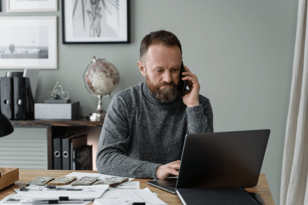 Man in Gray Sweater Working in the Office