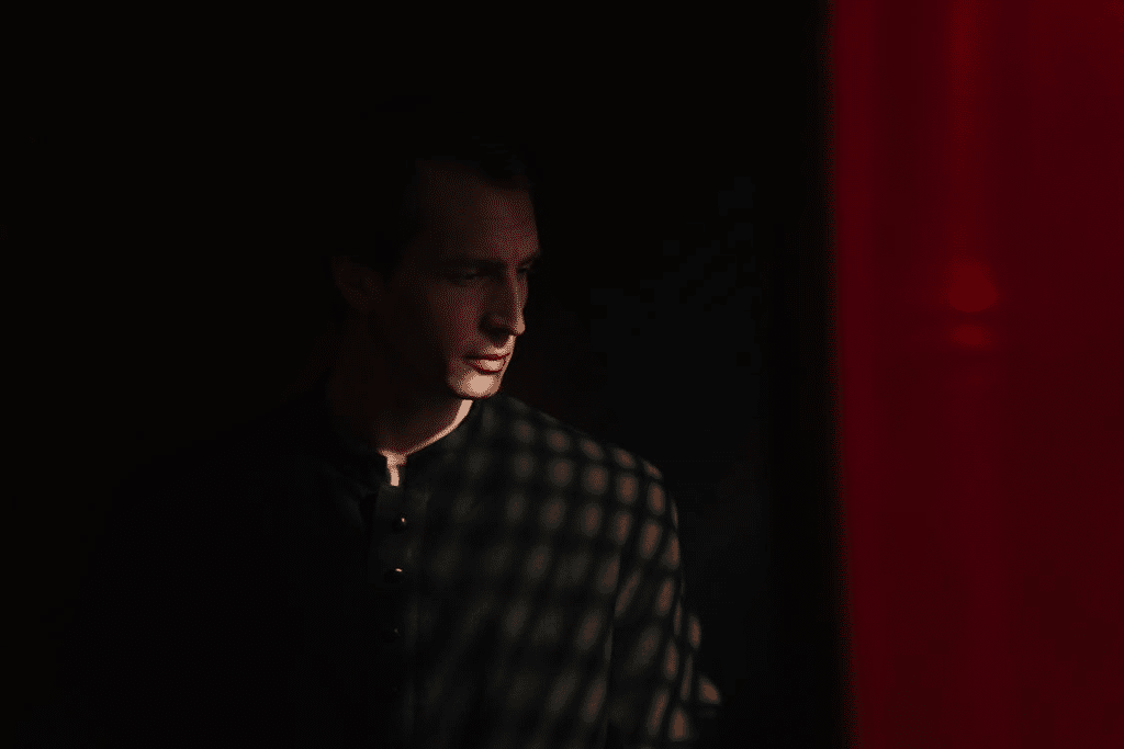 A Male Priest in a Confessional