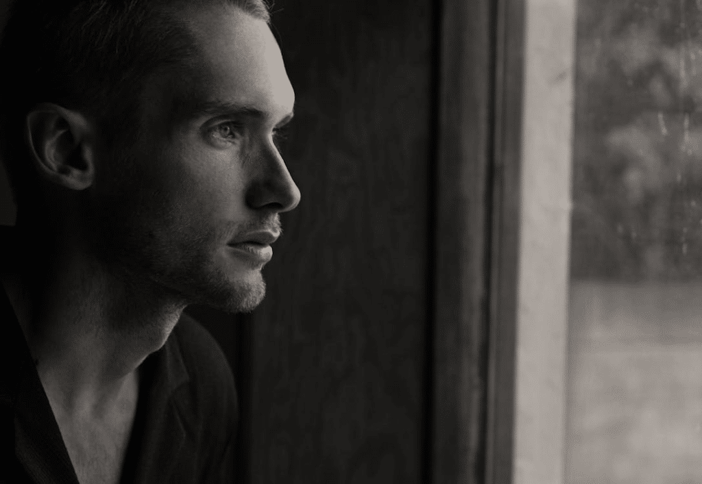 A man facing the window