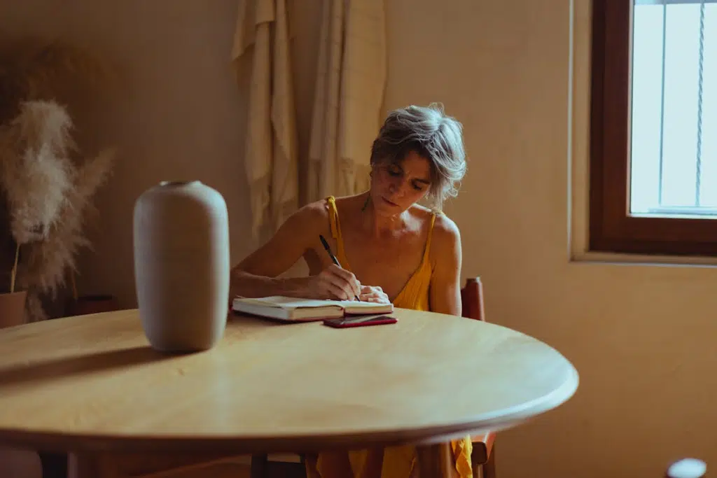 A woman writing on the table