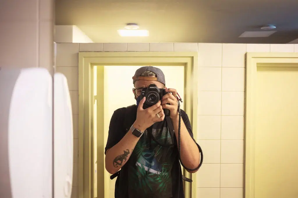 A man taking photos in a bathroom