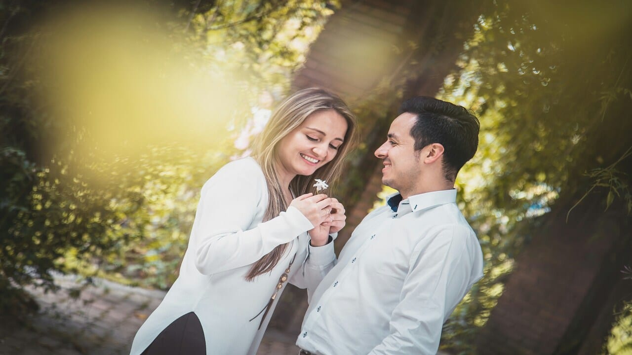 A man giving his date a flower