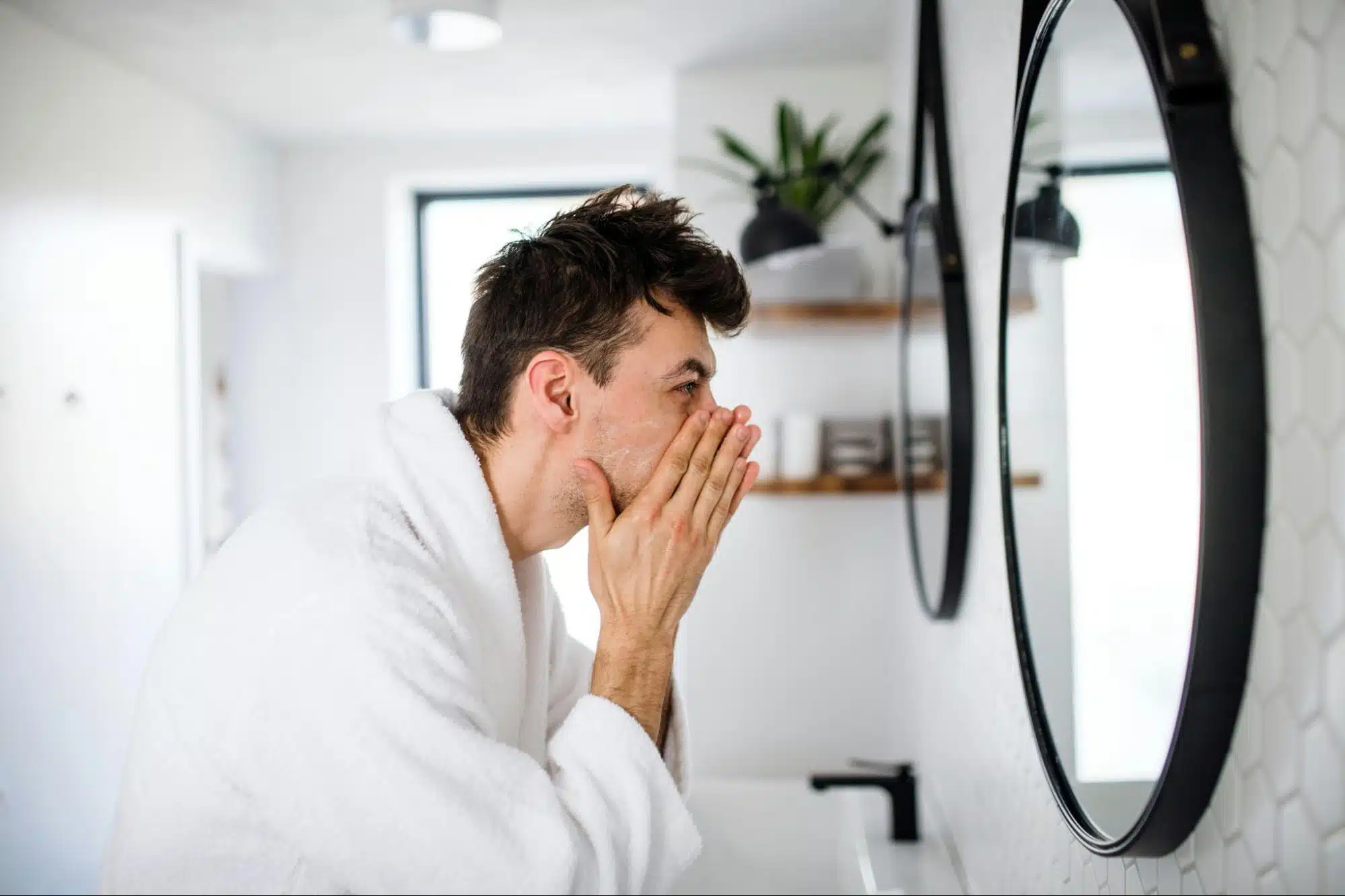A man looking at the mirror
