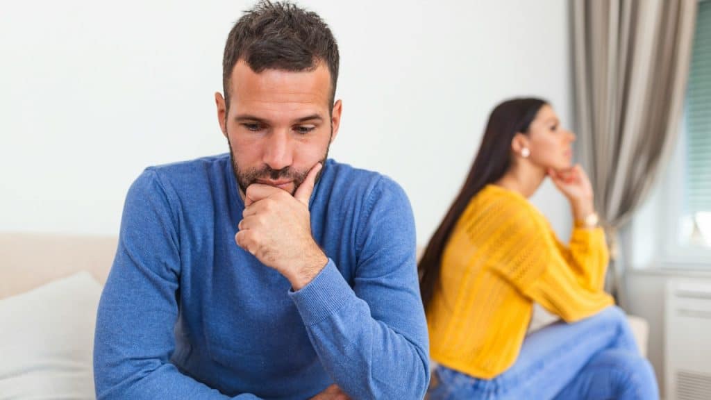 A man and woman sitting quietly after an argument.