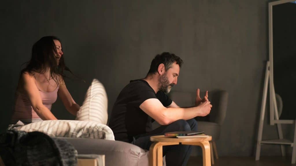 A rude husband is ignoring his crying wife.